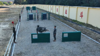 Armed police soldiers in military 400 meters steeplechase