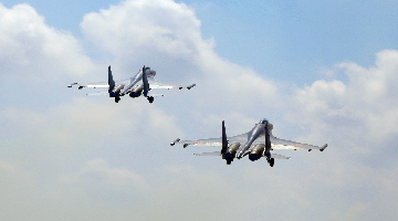 J-11 fighters , JH-7 fighter bombers execute flight training