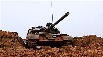 Type-59 tank crosses muddy trench