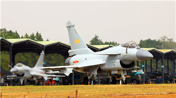 J-10 fighter jets taxi out of hangars