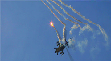 Attack helicopters deploy flares during training