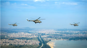 Transport helicopters fly over urban area