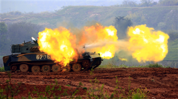 Self-propelled howitzer system fires at mock target
