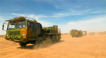 Military truck convoy in long-distance maneuver