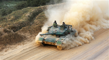 Main battle tank throws up dirt during maneuver training