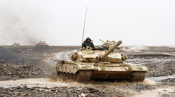 Tanks rumble through dirt roads