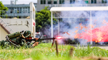 Flamethrower operators burn down mock targets