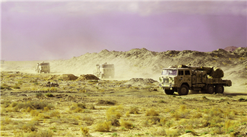 Artillerymen fire portable rockets in desert