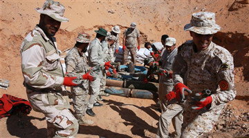 Fighters of UN-backed Libyan government move explosive remnants in old military camp in Libya