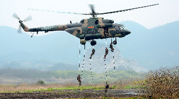 Soldiers fast rope from transport helicopter