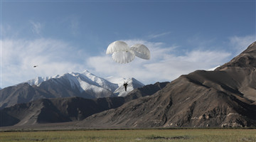 Special operations troops parachute in plateau area