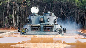 Armored vehicle wades through water obstacles