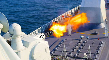 Destroyer fires at mock sea targets during training assessment
