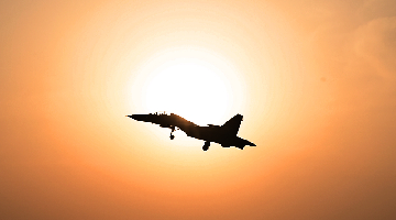 Fighter jet flies at sunrise during training