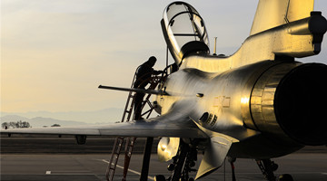 Fighter jet in daytime flight training exercise