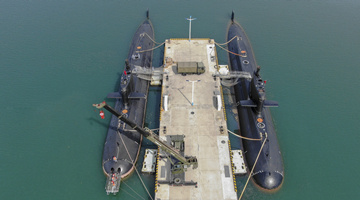 Submarines get missile loading at pier