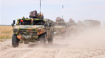 Armored assault vehicles in long-distance maneuver training