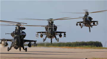 Attack helicopters hover above ground