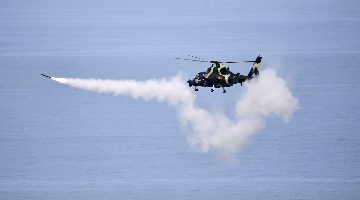 Attack helicopters fire at maritime targets in exercise