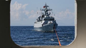 Naval frigates in combat training at sea