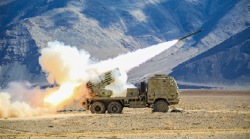 Truck-mounted artillery system fires at mock targets